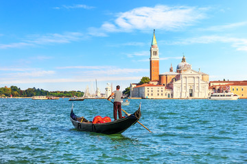 Fototapeta na wymiar Venetian gondolier near San Giorgio Maggiore Island, Venice, tal