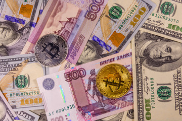 Bitcoin coins on the american and russian banknotes