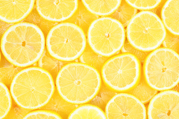 A slices of fresh juicy yellow lemons.  Texture background, pattern.