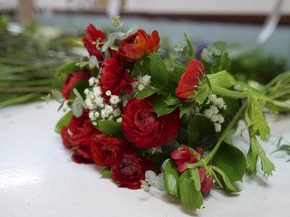 Red roses bouquet on a table in a greenhouse