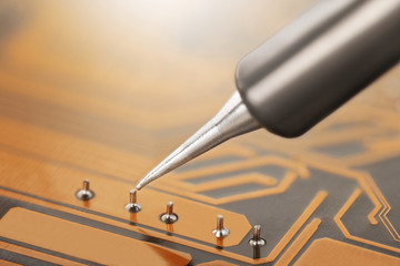 Work in progress. Soldering of electronic circuit board with electronic components. Soldering...