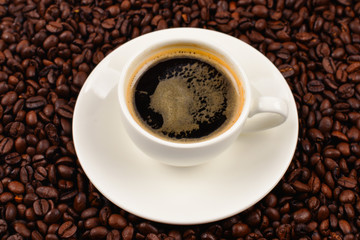 Obraz premium Cup of coffee and coffee beans.