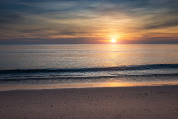 Fototapeta na wymiar Sunset and the sea in orange dark sky.