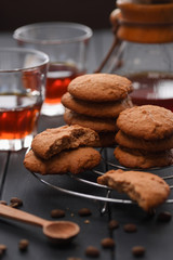 Homemade sweets. Oatmeal cookies served with drip coffee on dark background