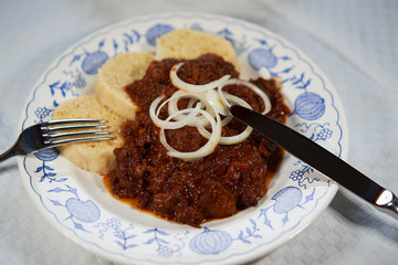 Slow cooked czech or hungarian beef goulash stew served with traditional czech dumplings and choped...