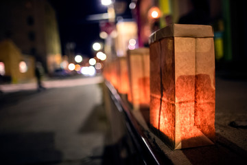 festive luminarias lined along a downtown street - 239210807