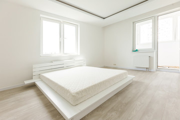 Assembling wooden bed in room