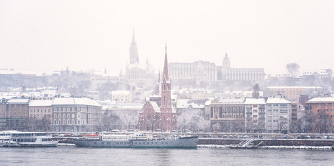 Fototapeta na wymiar View on Buda riverbank covered in snow in Budapest, Hungary