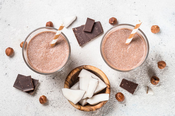 Fototapeta na wymiar Chocolate coconut hazelnut milkshake or smoothie top view.