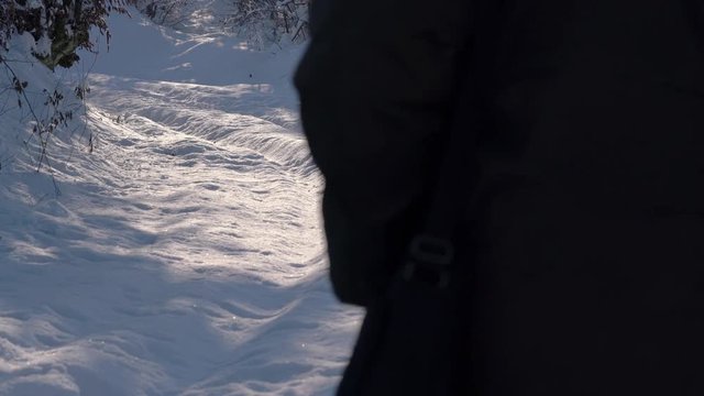Man goes in deep snow under branches - (4K)