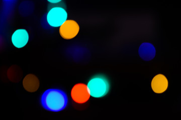 Bokeh. Christmas tree lights. Holiday background. Garland. Glitter. Christmas eve. Defocused sparkles. New Year backdrop. Blinks. Carnival. Bokeh retro style photo.