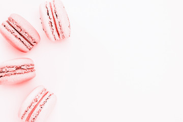 Pink macaroons on the liht pink background.