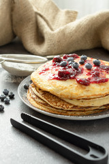 Pancakes with blueberries on a plate. Sweet breakfast or snack.