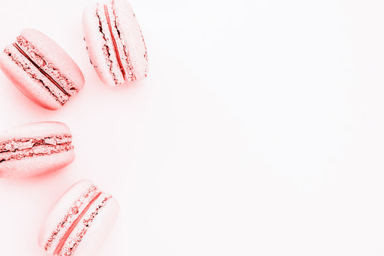 Pink macaroons on the liht pink background.