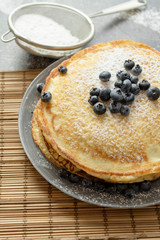 Pancakes with blueberries on a plate. Sweet breakfast or snack.