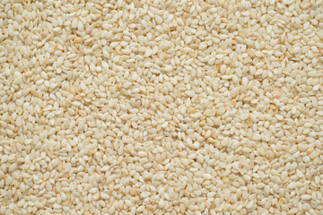 Raw white sesame seeds, top view, abstract background