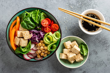 Buddha bowl salad with chickpeas, sweet pepper, tomato, cucumber, red cabbage kale, fresh radish,...