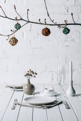 Christmas place setting on white rustic table