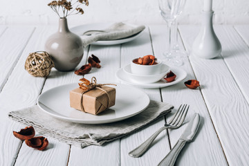 Christmas place setting on white rustic table