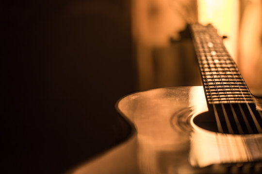 acoustic guitar close-up on a beautiful colored background