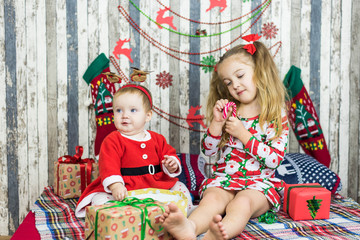 Merry Christmas and Happy Holidays! Xmas Christmas photo of surprised happy family Two little sisters