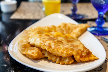 Traditional Tatar dish, chebureki. Puff pastry pie with meat filling.