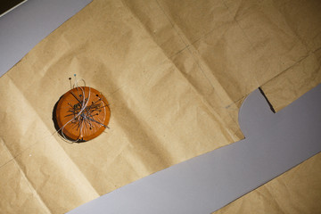 A magnet with a bunch of needles lies on the patterns. Sewing clothes.Sewing clothes.Tailor industry