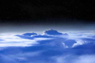 Wonderful panorama from window of plane with white clouds