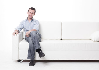 young man sitting on a modern sofa