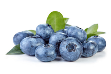 heap of ripe blueberry with leaves isolated on white background