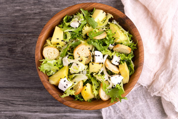 Delicious salad with frisee, mango, feta and crunchy croutons
