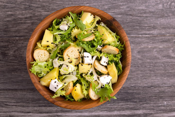 Delicious salad with frisee, mango, feta and crunchy croutons