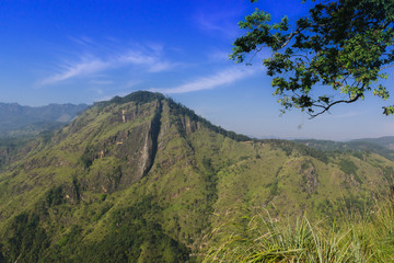 Beautiful view from little Adams peak at Sri Lanka. Fresh nature background. High mountain with trees, blue sky.