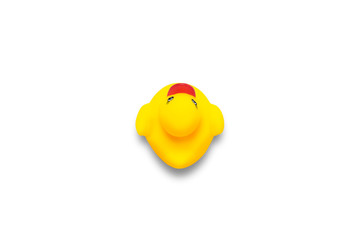 Yellow toy duck on a white background. Flat lay, top view