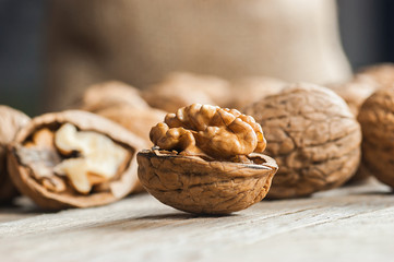 Pile whole big walnut kernel with thin shell on wooden vintage rustic backdrop. healthy food for brain. Fresh walnuts background concept 