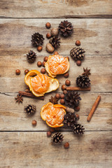 Tangerines, cones, spices on a wooden background. Сoncept of New Year and Christmas, Christmas drink Mulled wine. Flat lay, top view