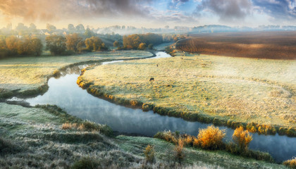 picturesque autumn dawn. beautiful clouds over the picturesque river. foggy morning