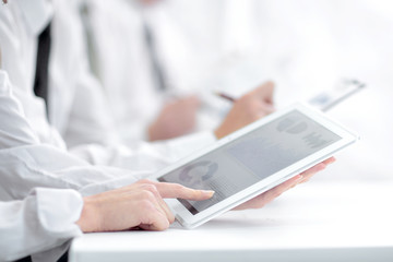 Fototapeta premium close up.an employee uses a digital tablet at a work meeting