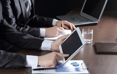 close up.businessman using digital tablet to check financial dat