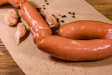 Heap of sausages, garlic and spices on a brown wrapping paper