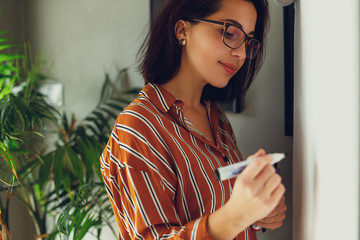 Businesswoman wear glasses in office, draw plan on the desk and think about new ideas with pen. Girl using pen for draw, copy space