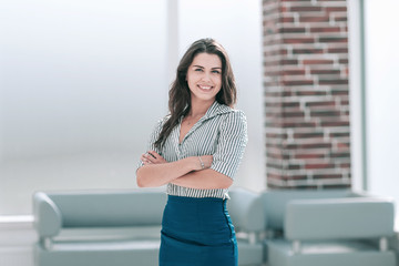 smiling young business woman standing in the office lobby