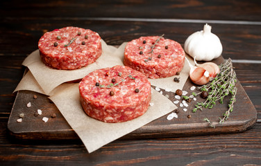 Home HandMade Minced Beef burgers on cutting board.  wooden table