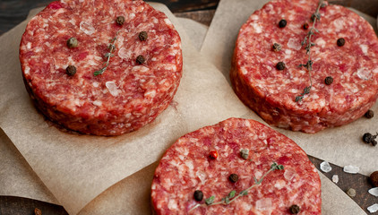 Home HandMade Minced Beef burgers on cutting board.  wooden table