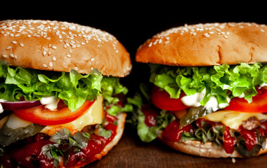 two delicious  homemade burger for slicing beef on a wooden table