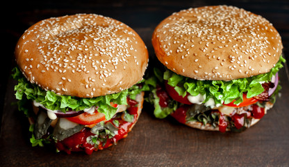 two delicious  homemade burger for slicing beef on a wooden table