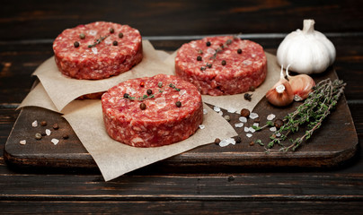 Home HandMade Minced Beef burgers on cutting board.  wooden table