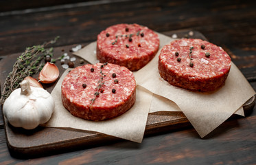 Home HandMade Minced Beef burgers on cutting board.  wooden table