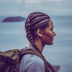 Portrait of a hiker girl with braided hair and a backpack in Thailand.