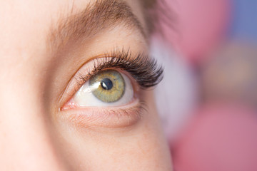 Beautiful Woman with long lashes in a beauty salon. Eyelash extension.